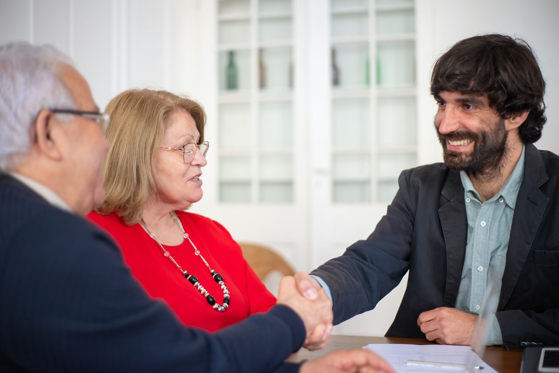 Business professionals engaged in a positive office meeting, sealing a deal with a handsha